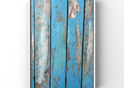 Nahaufnahme der Oberfläche eines Holztisches mit blauen Lackresten