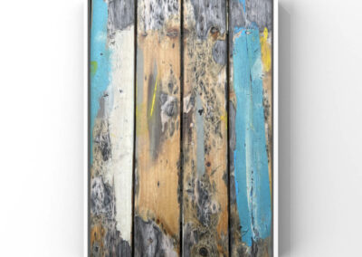 Nahaufnahme der Oberfläche eines Holztisches mit blauen und gelben Lackresten
