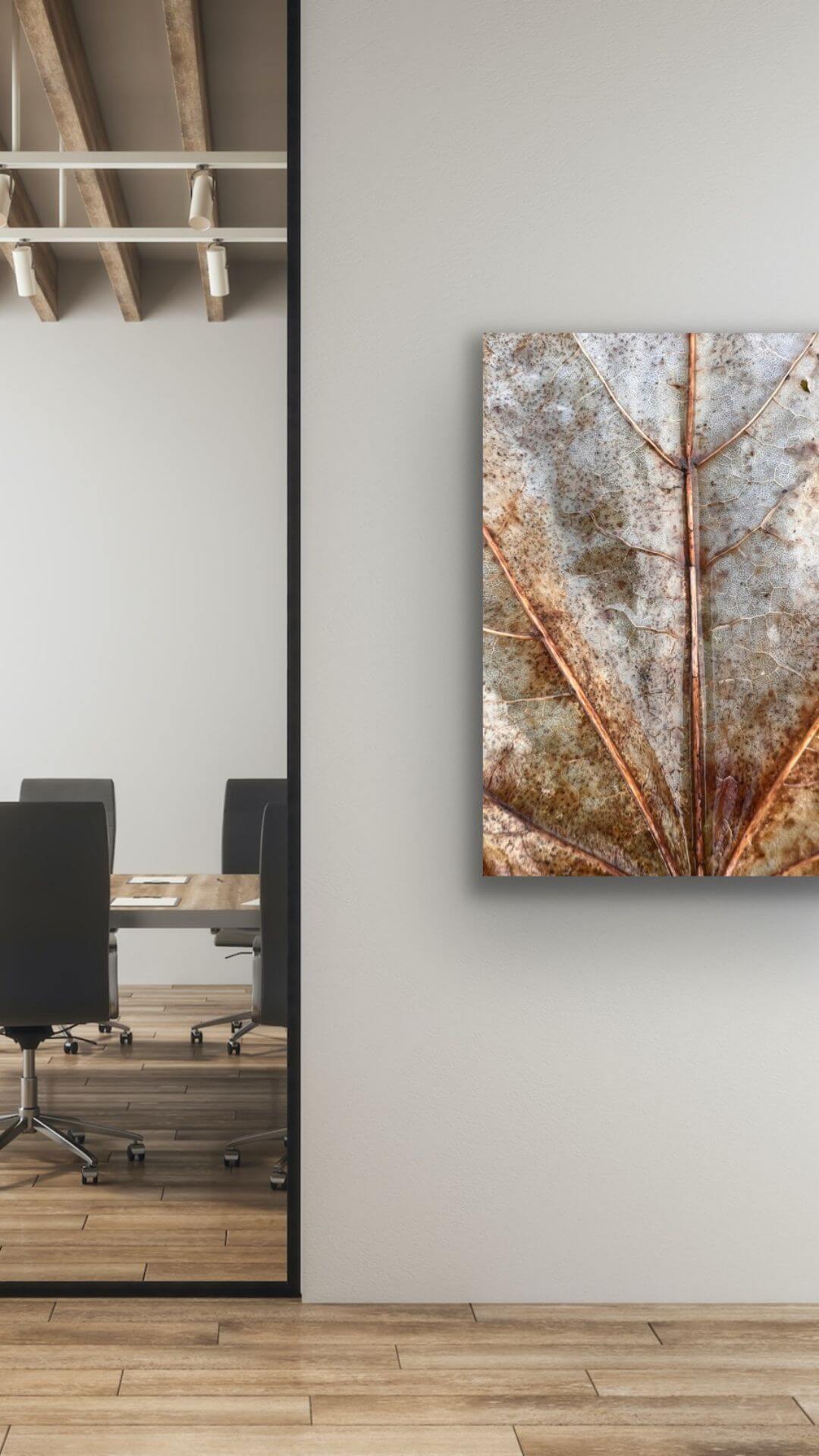 Detailfotografie eines Laubblattes an der Wand eines Besprechungsraums im Unternehmen